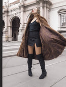 Brown mink fur swing coat with oversized hood and flared sleeves, side view