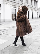 Brown mink fur coat with plush hood and roomy sleeves, front view