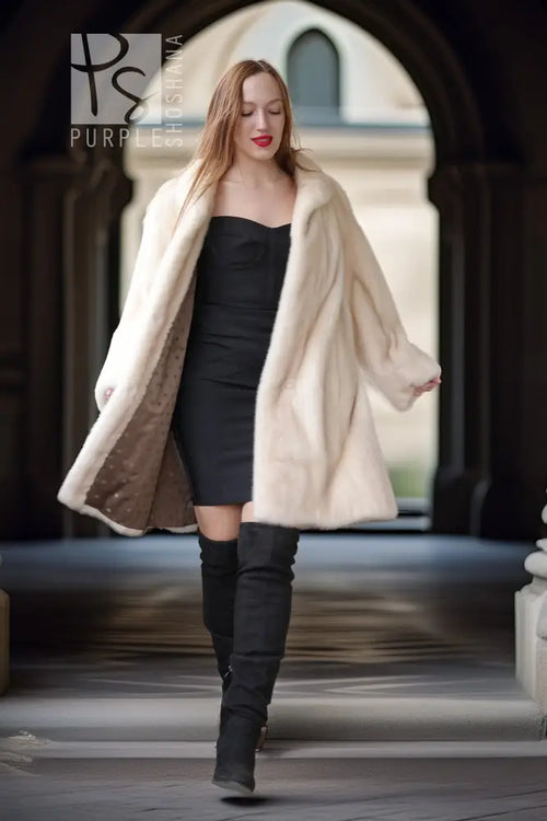 Pearl mink swing coat with hood, cream fur drape over dark mini dress and boots