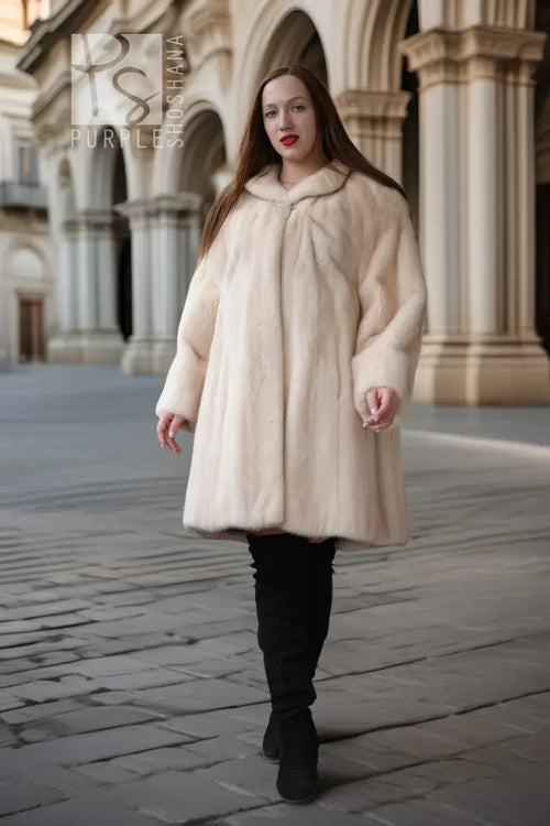 Cream mink coat with wide swing silhouette and plush collar; long sleeves