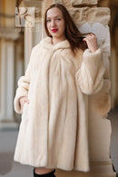 Close-up cream mink coat with plush collar and textured fur cuffs