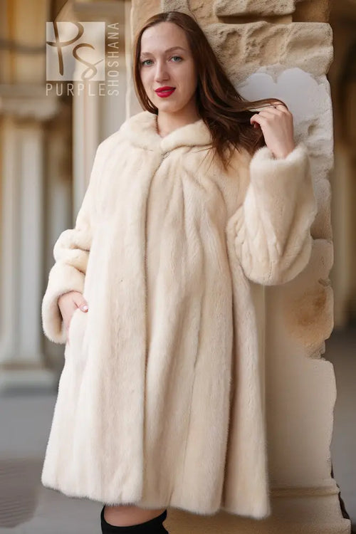 Close-up cream mink coat with plush collar and textured fur cuffs