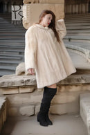 Cream mink coat, side view with plush collar and voluminous swing shape