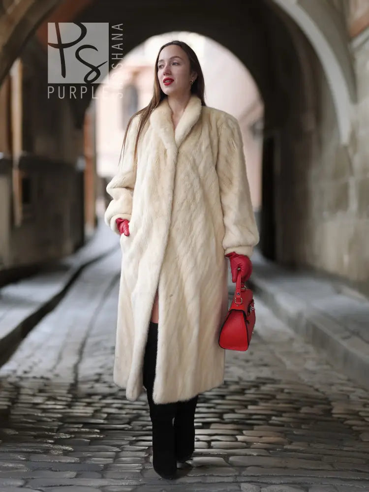 Cream fur coat with open front and shawl collar; full-length walkway view