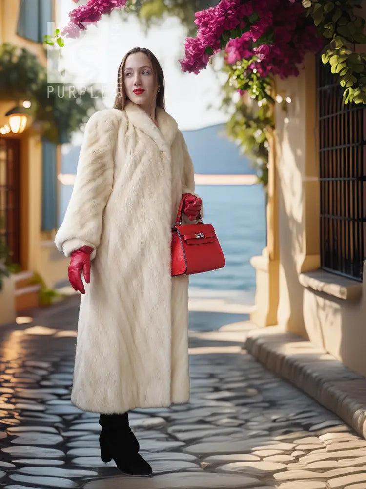 Cream long fur coat with diagonal design, stand collar, red knit cuffs, side pockets.