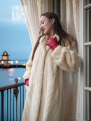 Cream fur coat with open front and shawl collar; partial side profile