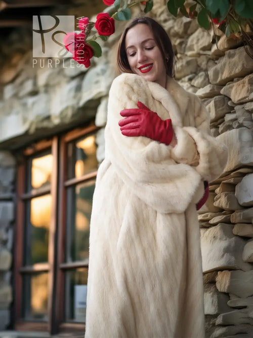 Cream fur coat with plush cuffs and structured shoulder detail
