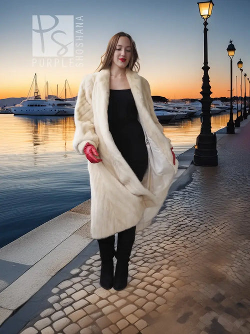 Cream fur coat with diagonal design, long sleeves and side pockets, full length.