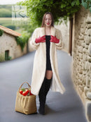 Cream fur coat layered over a black dress, open front and wide collar