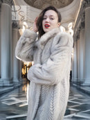 Light gray mink-style coat with thick fur hood and soft textured chevron pattern.