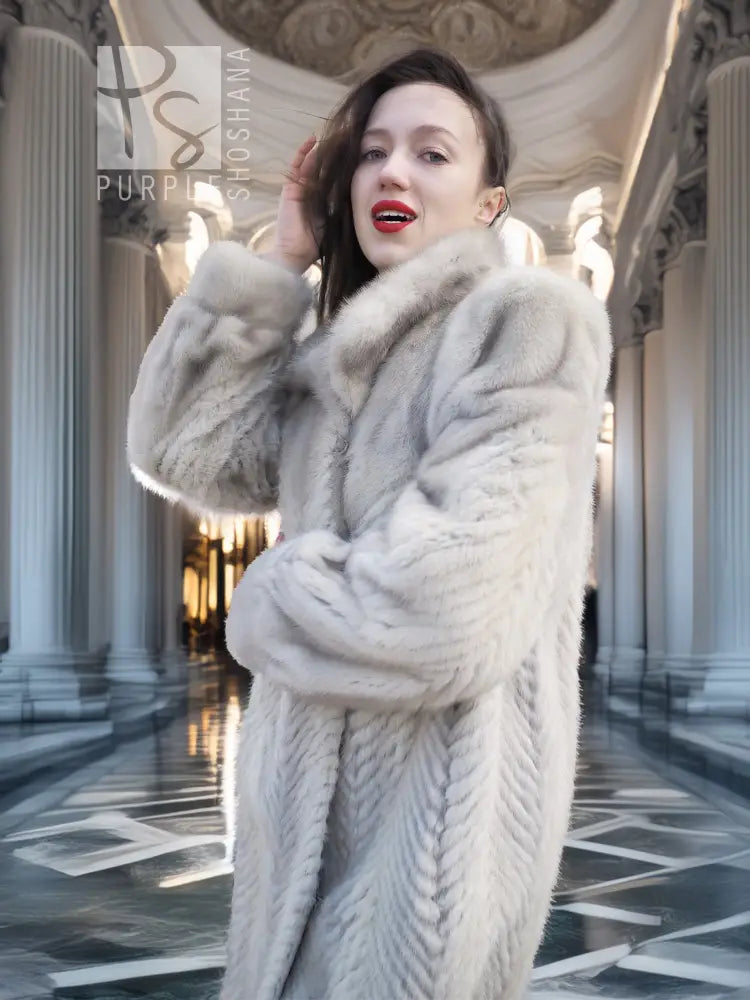 Light gray mink-style coat with thick fur hood and soft textured chevron pattern.