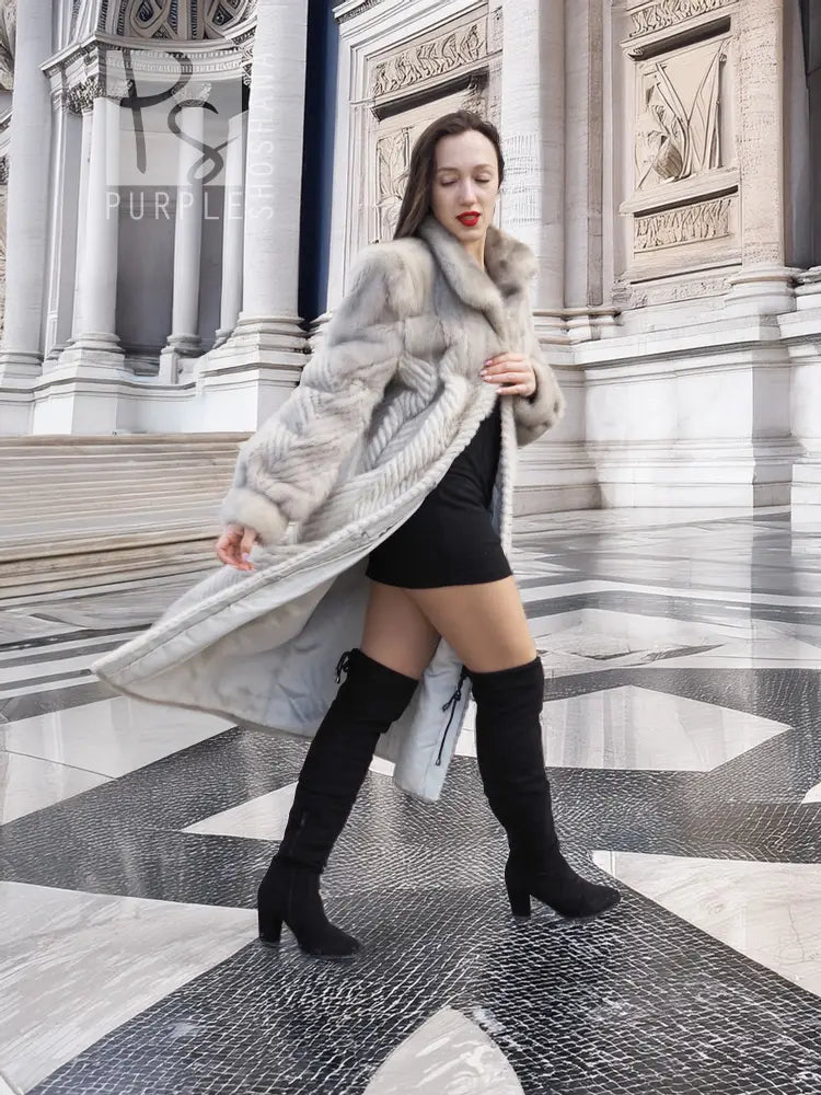 Hooded mink fur coat with herringbone texture, light gray; open front with dark leggings.