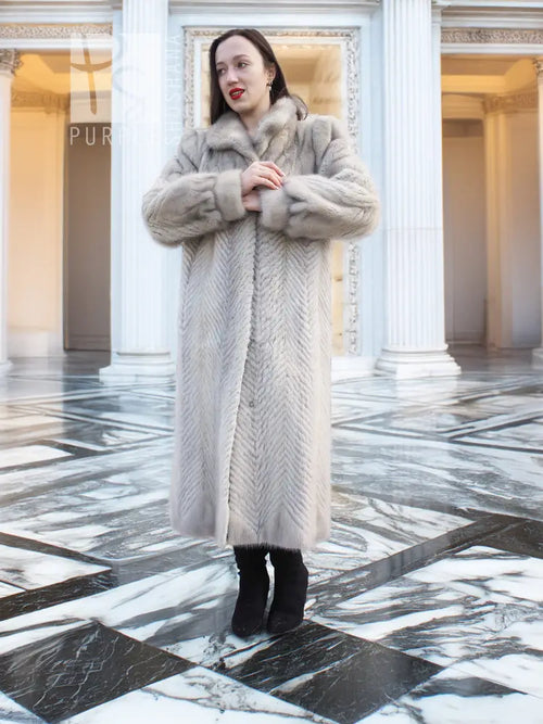 Light gray herringbone mink coat, front view with clasped hands near button placket