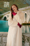 White fur coat with red cuffs and soft, plush texture, long sleeves and full length