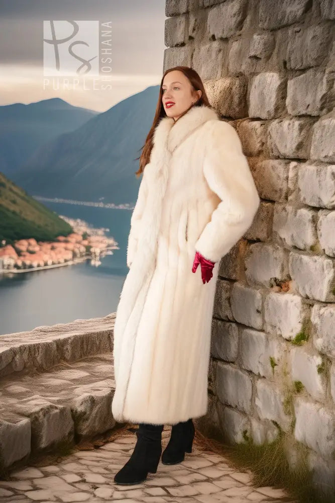 White mink fur coat with fox fur trim, long sleeves and open front, red cuffs
