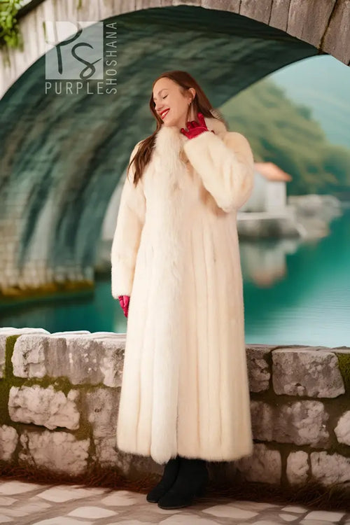 White fur coat with red fox-trim collar, long sleeves, ankle-length hem