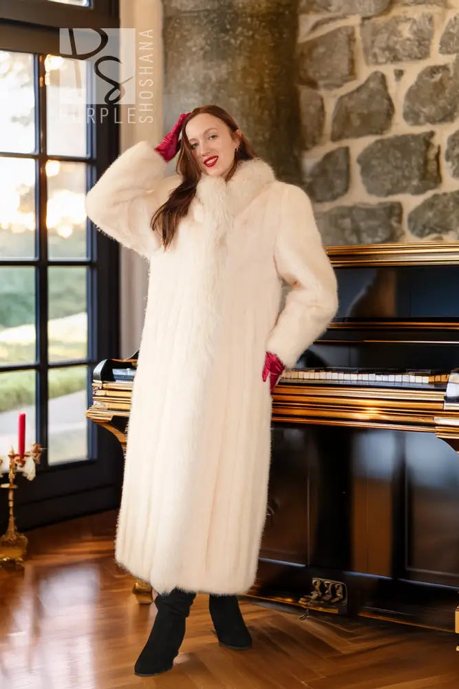 White mink fur coat with red fox-trim cuffs, plush texture, open front, long sleeves