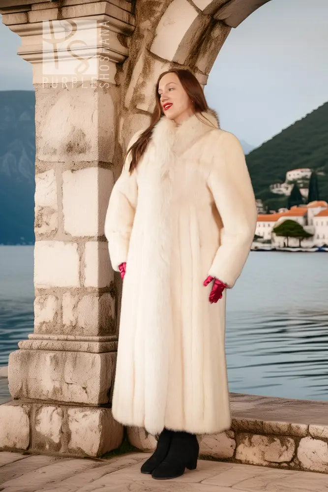 White fur coat with red cuffs and high collar, long sleeves, outdoor waterfront setting