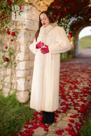 White fur coat with red fox-trim cuffs and long sleeves, full-length style