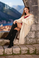 White fur coat with red fox-trim collar and cuffs, long sleeves, seated pose