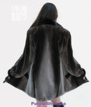 Back view of dark beaver fur bomber coat with swing hem and cuffed sleeves