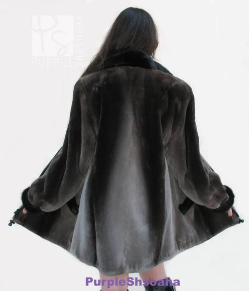Back view of dark beaver fur bomber coat with swing hem and cuffed sleeves