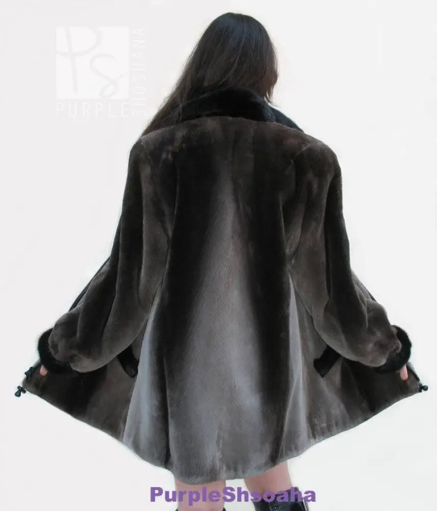 Back view of dark beaver fur bomber coat with swing hem and cuffed sleeves
