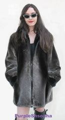 Black beaver fur bomber coat with front zipper and stand collar, relaxed fit