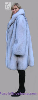 Light blue fox fur coat shown from the side with full sleeves and stand collar