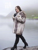 Light gray plush fur coat with shawl collar, long sleeves, worn with dark boots