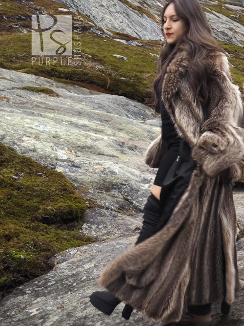 Raccoon fur coat for men, long hooded side view with belt tie and plush fur cuffs.