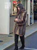 Raccoon fur coat, full-length with draped texture and side pockets, brown.