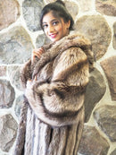 Brown raccoon fur coat with large hood and wide cuffed sleeves, striped fur