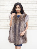 Sleeveless raccoon fur vest with textured shaggy fur and light trim at shoulders