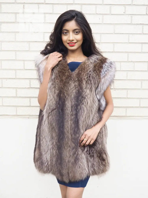 Sleeveless raccoon fur vest with textured shaggy fur and light trim at shoulders