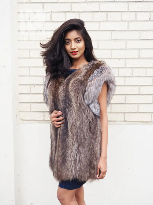 Unisex raccoon fur vest with contrasting light trim at neckline and armholes