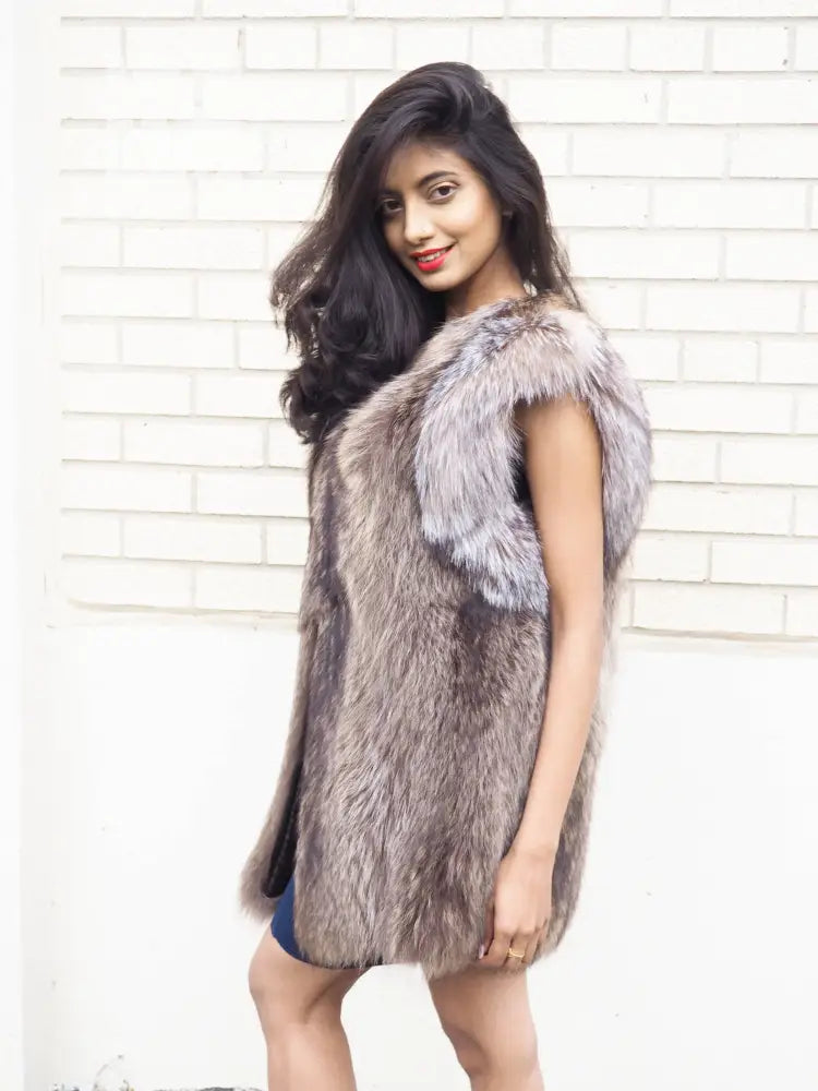 Side view raccoon fur vest with plush fur texture and contrasting light shoulder trim