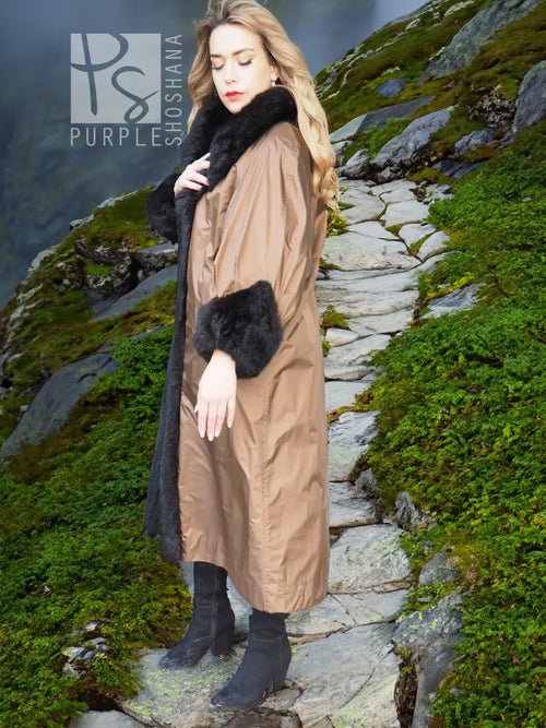 Reversible water-repellent tan coat with black plush cuffs and hem trim.