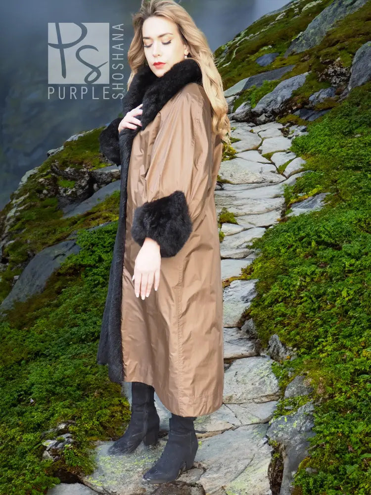 Reversible water-repellent tan coat with black plush cuffs and hem trim.