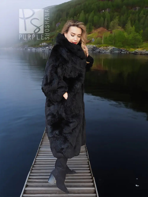 Black long plush fur coat with wide collar and full-length faux-fur body.