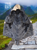 Black reversible plush fur coat with hood, textured panels, and long back length.