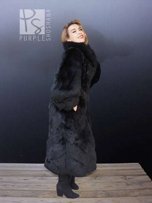 Black reversible plush coat with thick faux-fur texture and full-length sleeves.
