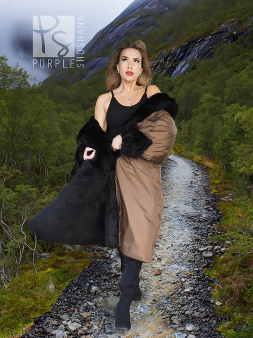 Reversible tan coat with black plush hood and side fur panels.