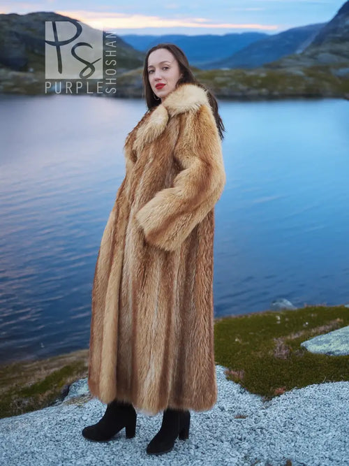 Long tan raccoon fur coat with textured fur and shawl collar, side profile view.