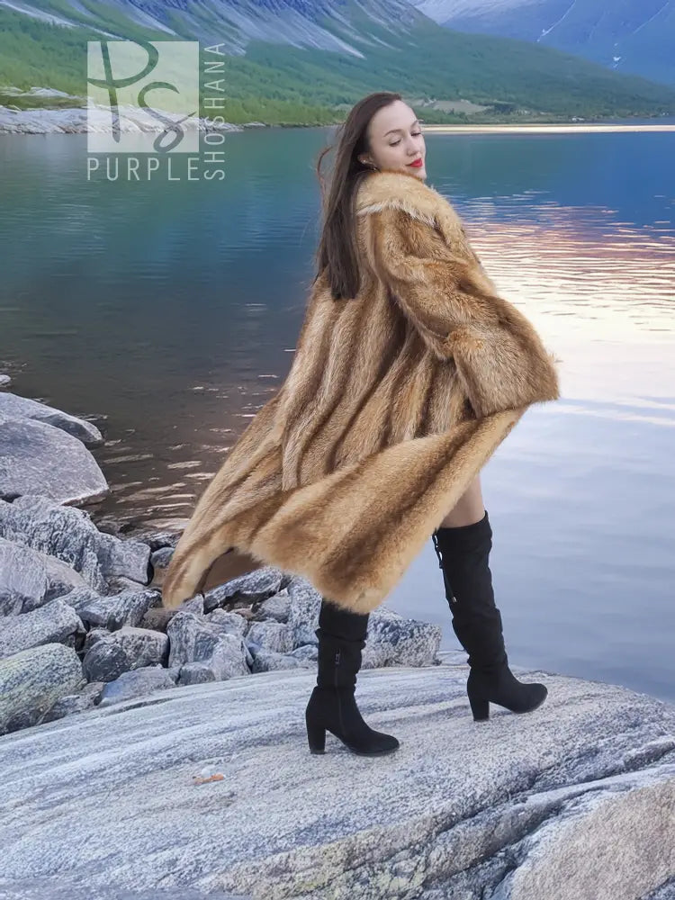 Tan raccoon fur coat with voluminous texture, shawl collar, and long sleeves, side view.