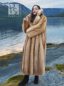 Tan raccoon fur coat with thick shawl collar and plush sleeves, arms-crossed portrait.