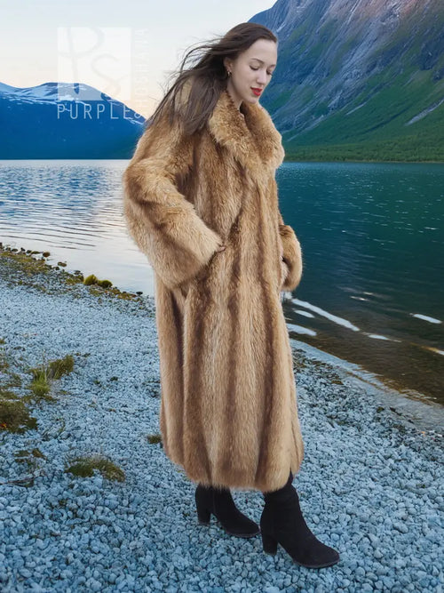 Tan raccoon fur coat with voluminous sleeves and shawl collar, side walking view.