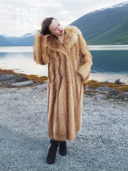Tan raccoon fur coat with thick shawl collar and long sleeves, angled side view.