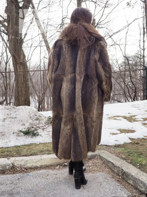 Back view of long raccoon-fur coat with central seam detail and flared hem