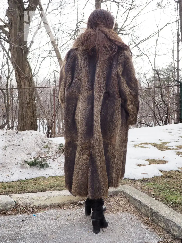 Back view of long raccoon-fur coat with central seam detail and flared hem